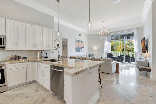 kitchen featuring white cabinetry, stainless steel appliances, sink, and kitchen peninsula