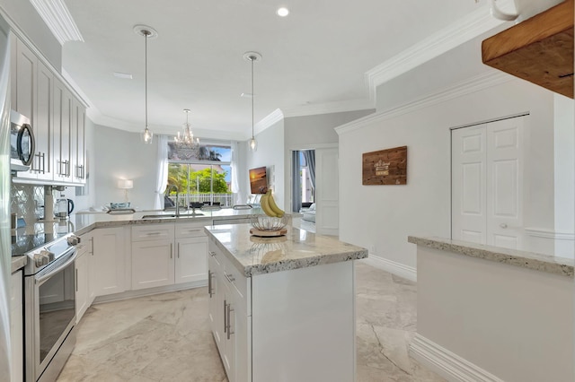 kitchen with white cabinets, hanging light fixtures, a center island, appliances with stainless steel finishes, and sink