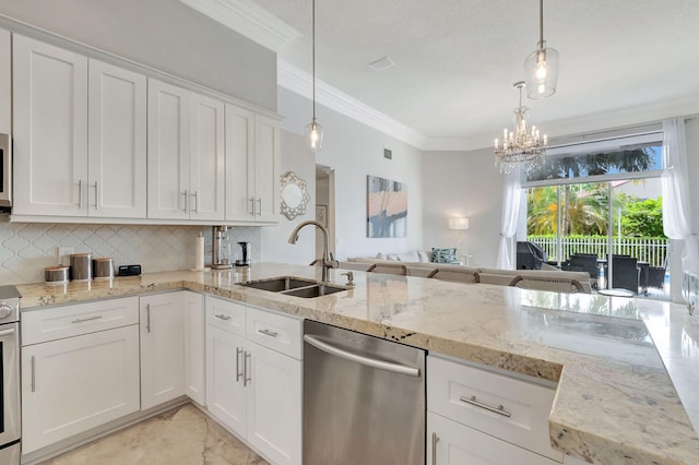 kitchen featuring an inviting chandelier, stainless steel appliances, sink, and white cabinets