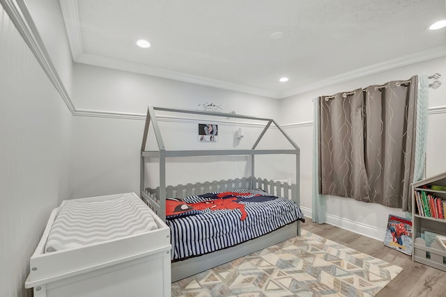 bedroom featuring light wood-type flooring and ornamental molding