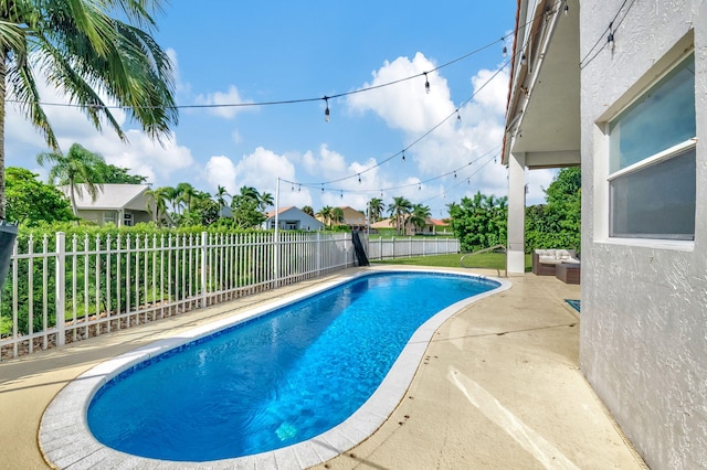 view of swimming pool featuring a patio area, a fenced backyard, and a fenced in pool