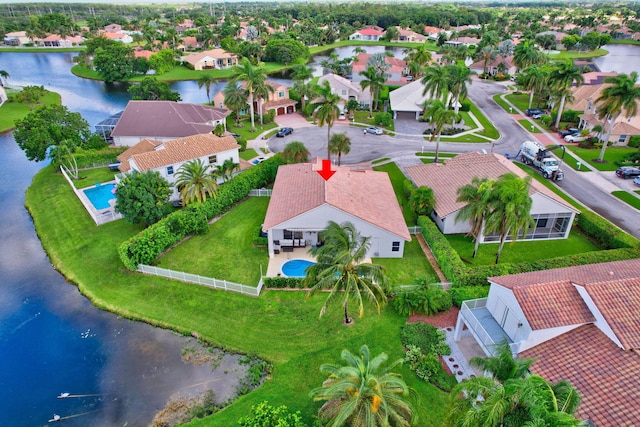 drone / aerial view featuring a water view and a residential view