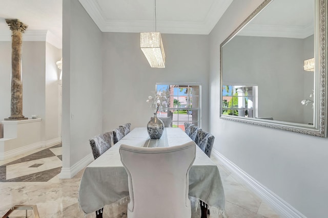 dining space featuring ornamental molding and ornate columns