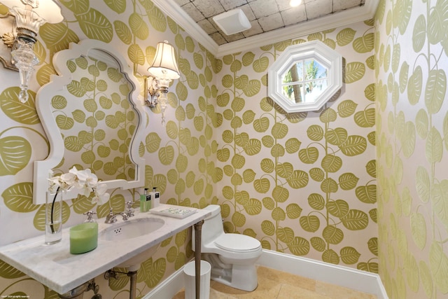 bathroom featuring toilet, ornamental molding, and sink