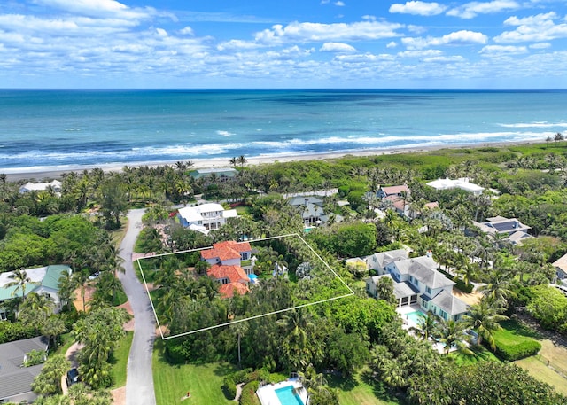 birds eye view of property featuring a view of the beach and a water view