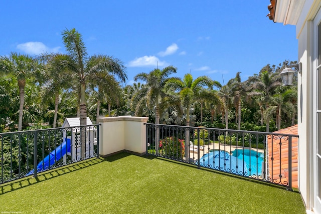 view of yard featuring a fenced in pool and a balcony