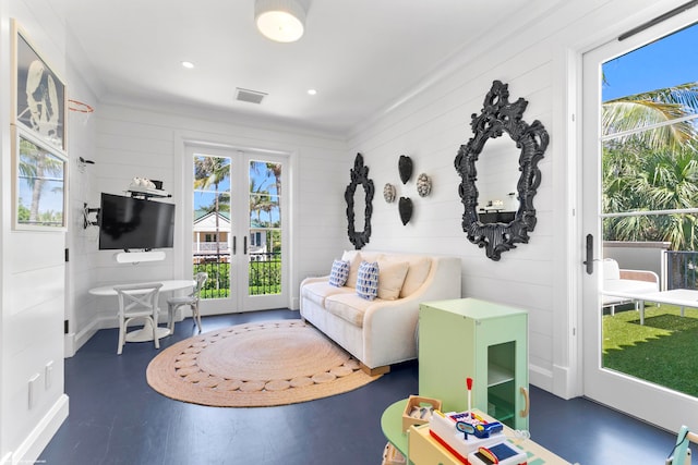 living room featuring crown molding, french doors, and a healthy amount of sunlight