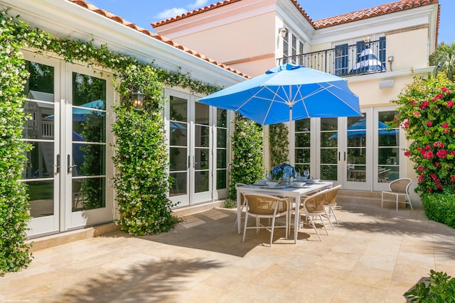 view of patio / terrace with a balcony and french doors