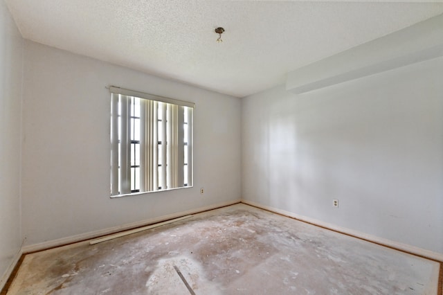 spare room with a textured ceiling