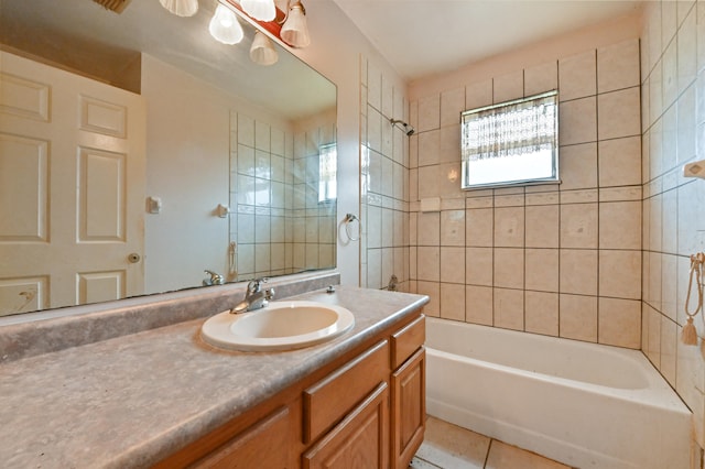 bathroom with tiled shower / bath, vanity, and tile patterned flooring