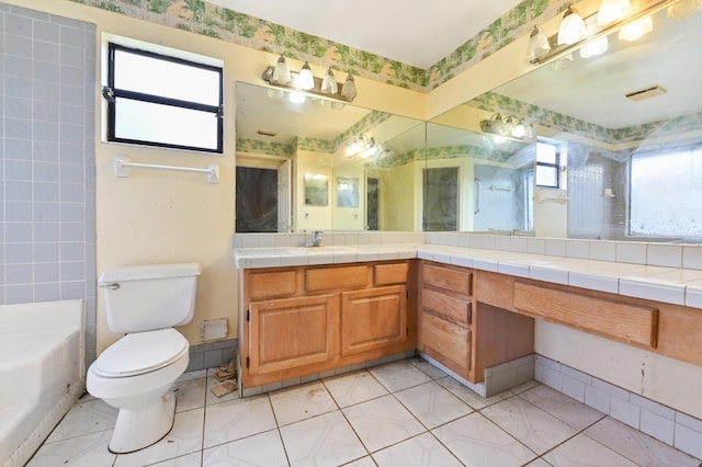 bathroom featuring a wealth of natural light, vanity, a tub, and toilet