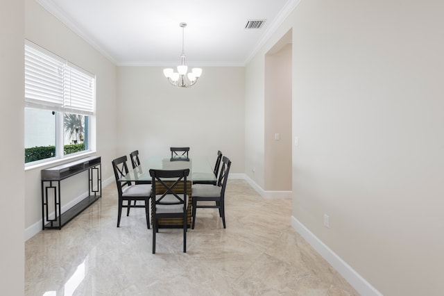 dining room with ornamental molding and a chandelier