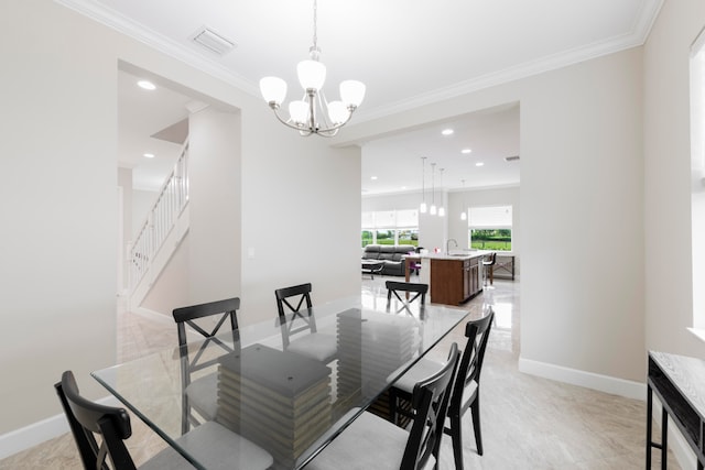 dining room featuring ornamental molding, a chandelier, and sink