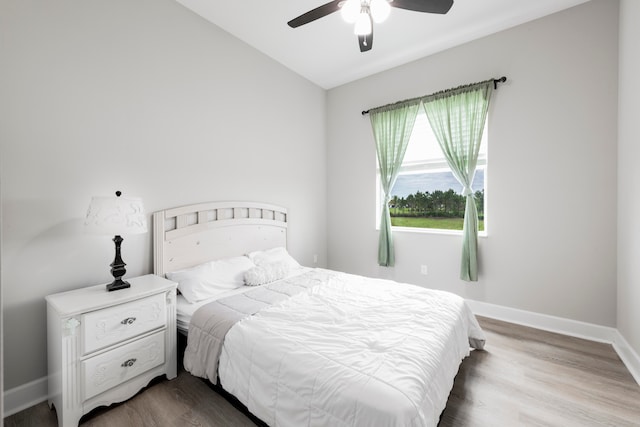 bedroom featuring lofted ceiling, wood-type flooring, and ceiling fan