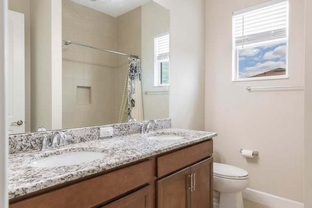 bathroom featuring vanity, toilet, and curtained shower