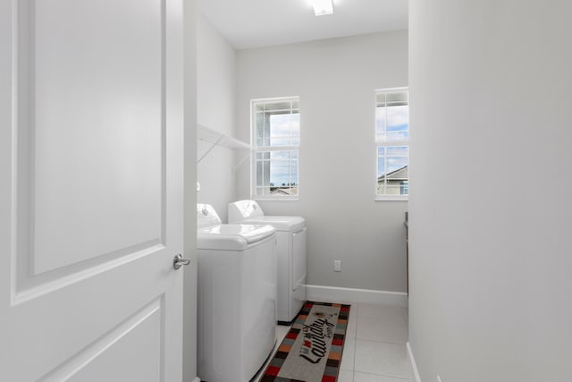 washroom with washer and dryer and light tile patterned flooring