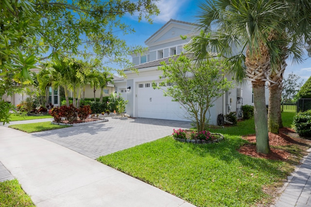 view of front of home featuring a garage and a front yard