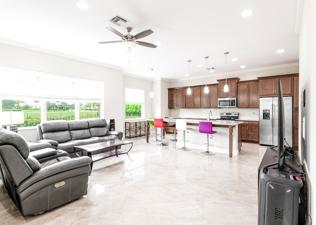 living room with ceiling fan, crown molding, and sink