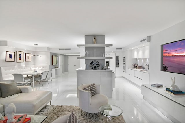 tiled living room featuring sink