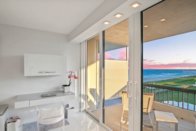 interior space featuring a beach view and a water view