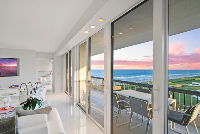 interior space featuring a view of the beach and a water view