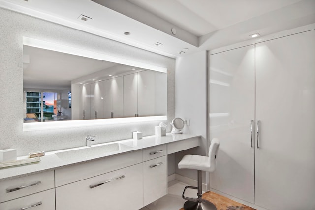 bathroom featuring tile patterned floors, a shower with door, and vanity