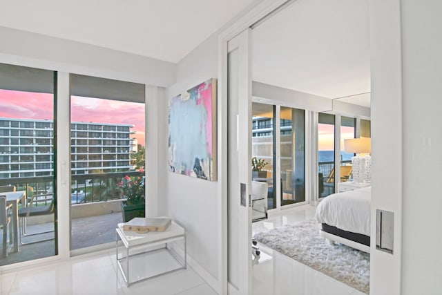 tiled bedroom featuring multiple windows and access to outside