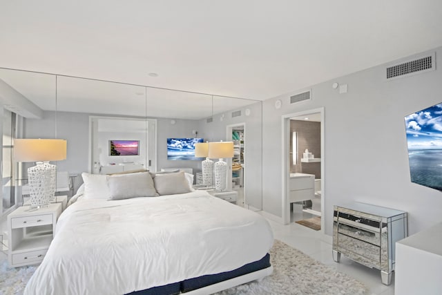 tiled bedroom featuring ensuite bathroom