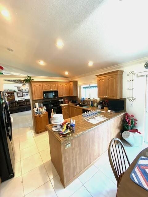 kitchen with kitchen peninsula, lofted ceiling, light tile patterned floors, black appliances, and ornamental molding