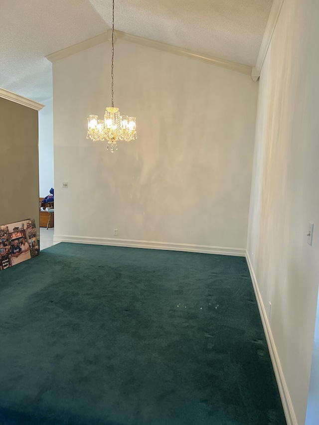 empty room featuring dark colored carpet, a chandelier, a textured ceiling, lofted ceiling, and ornamental molding