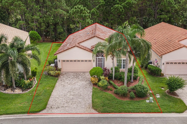 mediterranean / spanish-style home with a garage and a front yard