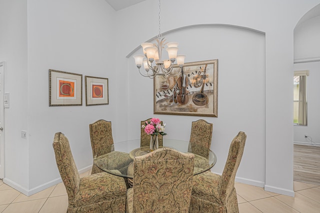 dining space with light wood-type flooring and a notable chandelier