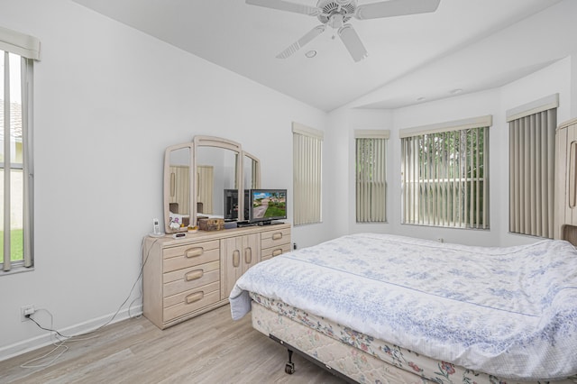 bedroom with light hardwood / wood-style flooring, ceiling fan, and vaulted ceiling