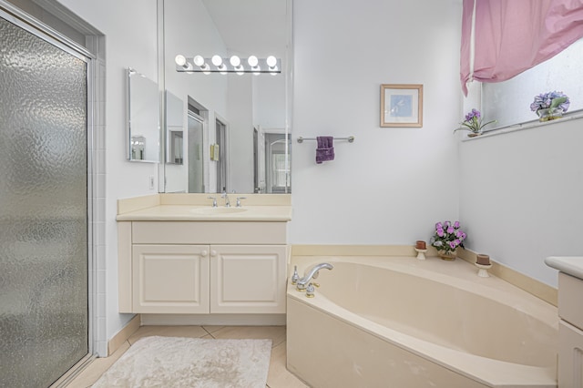 bathroom with tile patterned flooring, separate shower and tub, and vanity