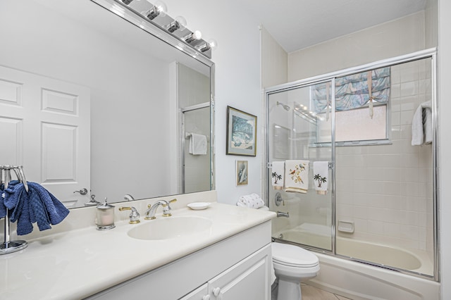 full bathroom featuring shower / bath combination with glass door, toilet, and vanity