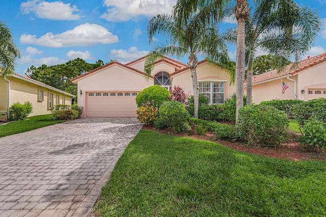 mediterranean / spanish-style home featuring a front yard