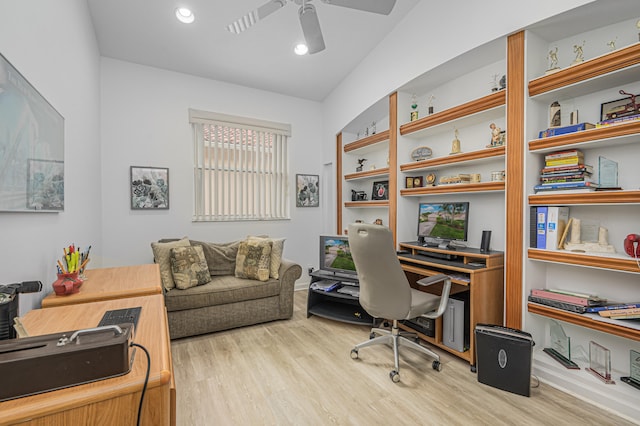 home office with light hardwood / wood-style flooring and ceiling fan