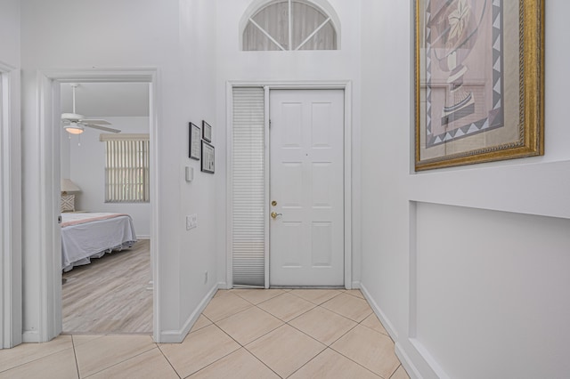 entryway with ceiling fan and light tile patterned floors