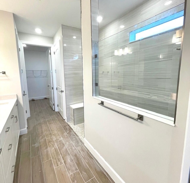 bathroom featuring vanity and tiled shower