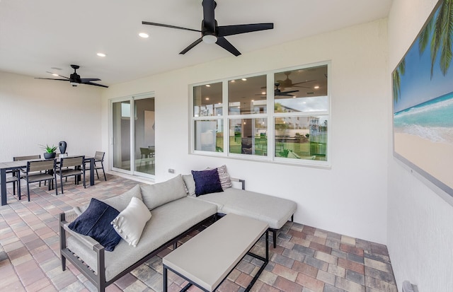 view of patio with an outdoor living space and ceiling fan