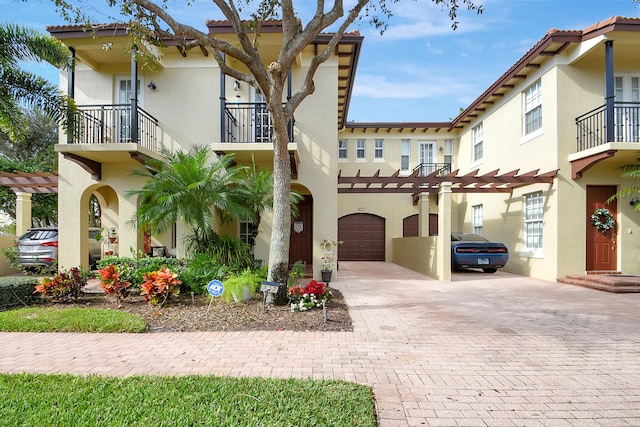 mediterranean / spanish-style home featuring a balcony and a garage