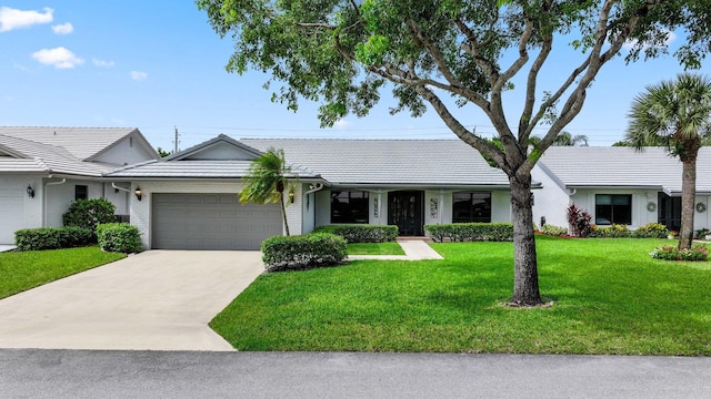 ranch-style home with a garage and a front yard