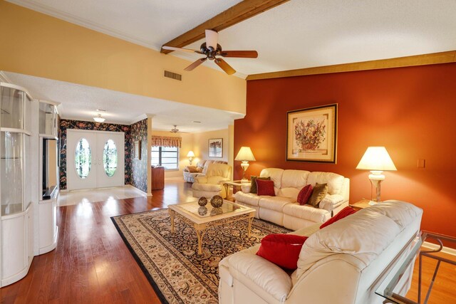 living room featuring hardwood / wood-style floors, ceiling fan, crown molding, and beamed ceiling