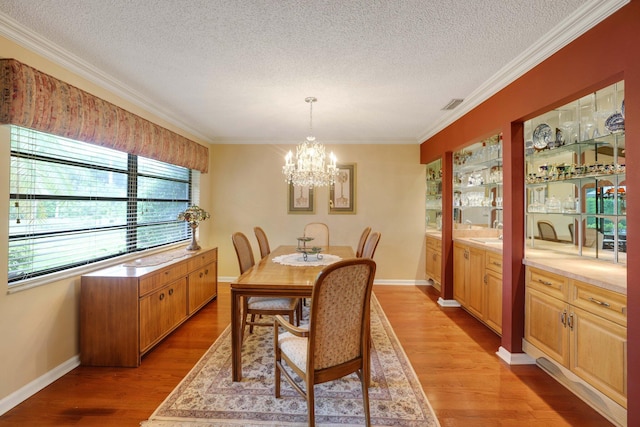 dining room featuring hardwood / wood-style flooring, a textured ceiling, and a healthy amount of sunlight