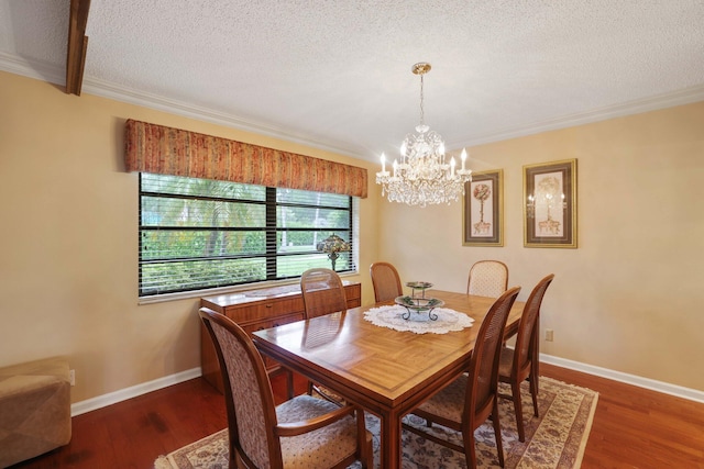 dining area featuring dark wood-type flooring, a chandelier, crown molding, and a textured ceiling