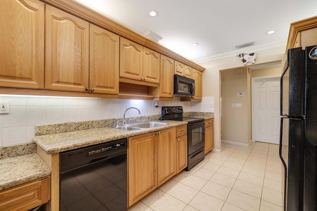 kitchen featuring ornamental molding, black appliances, light stone counters, sink, and decorative backsplash