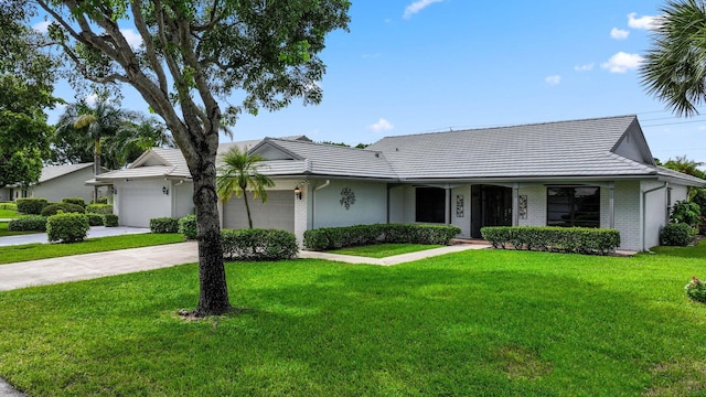 ranch-style home featuring a garage and a front yard