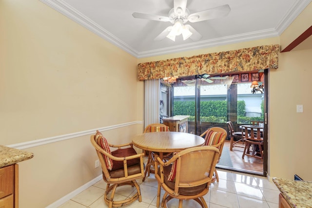 tiled dining room featuring ceiling fan and ornamental molding