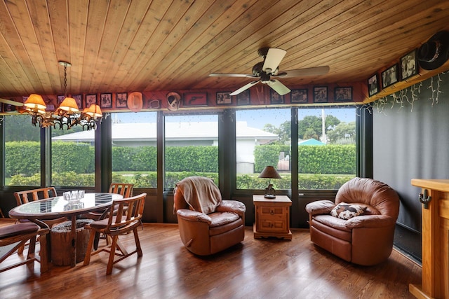 sunroom / solarium featuring ceiling fan with notable chandelier and wooden ceiling