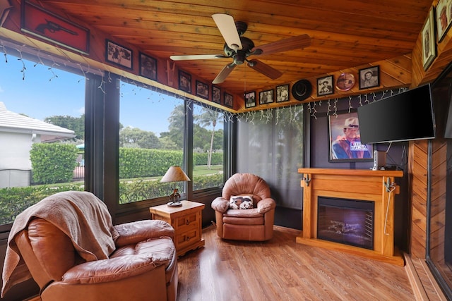 sunroom / solarium with wooden ceiling and ceiling fan